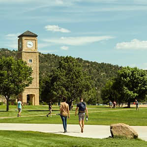 Students walking across campus near FLC's iconic clocktower